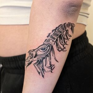 Unique and intricate tattoo design by artist Adam McDade, combining the motifs of an eye and a shrimp in a bold illustrative style.