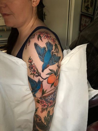 Neo-traditional illustrative tattoo by Elena Mameri featuring a bird, art deco, art nouveau, and peach motifs.