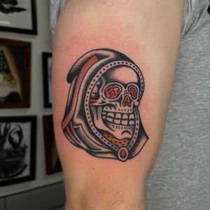 Get inked by renowned artist Sam Young with a classic design featuring skull and skeleton motifs in traditional style.