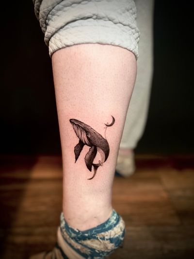 Nat's unique design features a dreamy scene of a whale fishing under the moon, created with intricate dotwork style.