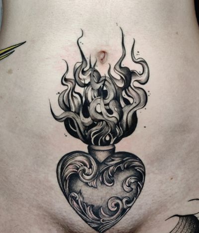 Intricate filigree meets bold blackwork in this stunning sacred heart tattoo by Mary Shalla.