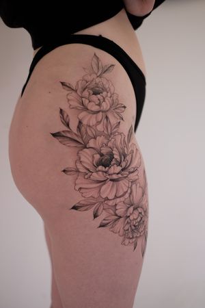 Adorn your skin with a delicate fine line peony by the talented artist Ion Caraman, perfect for those who appreciate floral tattoos.