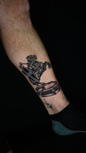 Checkmate with this stunning illustrative tattoo featuring a knight in a chess motif, designed by tattoo artist Miss Vampira.