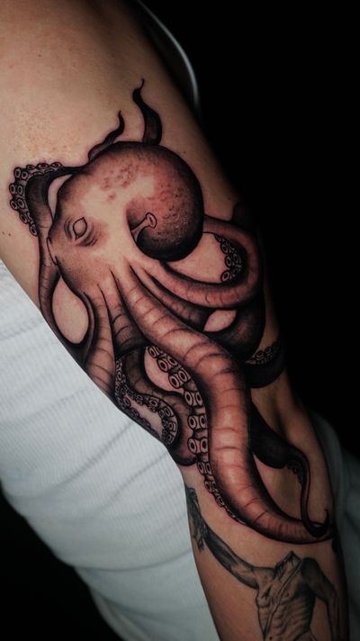 Get a stunning black and gray illustrative octopus tattoo that will captivate onlookers. Done by the talented artist, Miss Vampira.