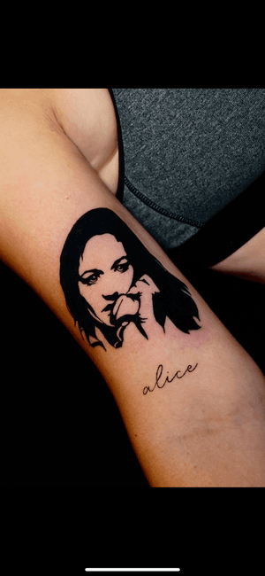Get a haunting blackwork tattoo of a woman screaming into a phone, artistically done by Miss Vampira. Unique and memorable ink guaranteed.