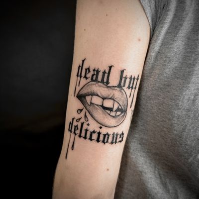 Get bitten by the beauty of this dotwork and illustrative tattoo featuring vampire lips by Jenny Dubet.