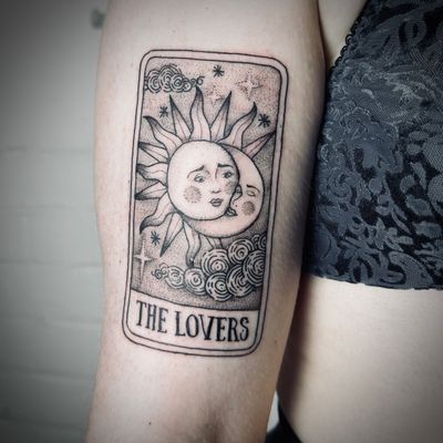 Intricate dotwork tattoo by Jenny Dubet featuring sun, moon, tarot cards & the lovers motif.