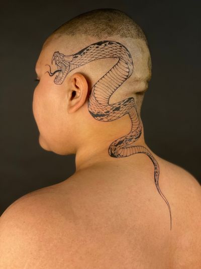 Get a stunning fine line snake tattoo by renowned artist Kat Jennings, perfect for those seeking a sleek and intricate design.