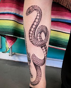 Captivating realism meets detailed illustration in this stunning snake tattoo created by the talented artist Hannah Senoj.