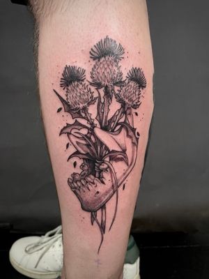Unique dotwork skull design entwined with prickly purple thistle, by talented artist Kat Jennings.
