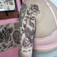 A stunning floral tattoo combining a bird, rose, and pigeon in a beautiful illustrative style by the talented artist Hannah Senoj.