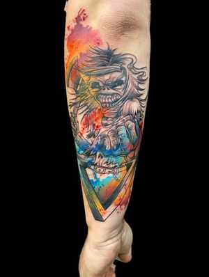 Vibrant watercolor tattoo featuring iconic Iron Maiden mascot Eddie the Head, by talented artist Eve Inksane.