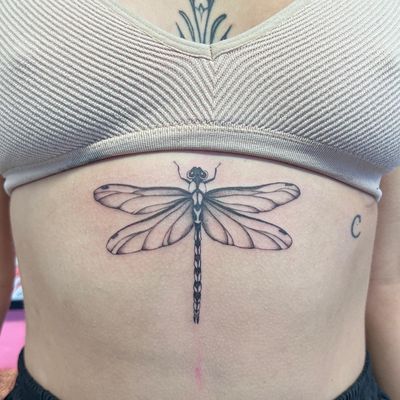 Adorn your skin with a stunning illustrative dragonfly tattoo by the talented artist Hannah Senoj. Embrace the beauty of nature with this elegant design.