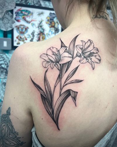 A stunning and detailed floral tattoo featuring a beautiful orchid, designed by the talented artist Hannah Senoj.