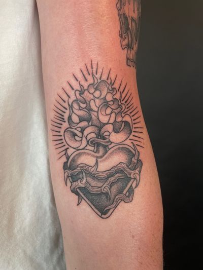 Experience the beauty and mystique of a black and gray illustrative sacred heart tattoo by the talented artist Kat Jennings. Embrace the power and symbolism of this timeless design.