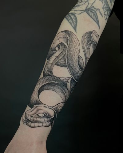 Capture the beauty of nature with this dotwork and fine line snake tattoo by Kat Jennings. A classy and unique piece for your collection.