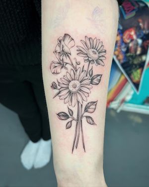 Beautiful flower tattoo by artist Hannah Senoj, featuring intricate details and vibrant colors. Perfect for nature lovers!