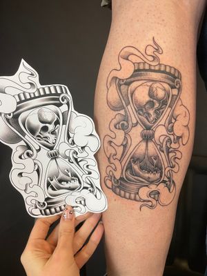 Unique black and gray illustrative tattoo combining skull and hourglass motifs in dotwork style by talented artist Kat Jennings.