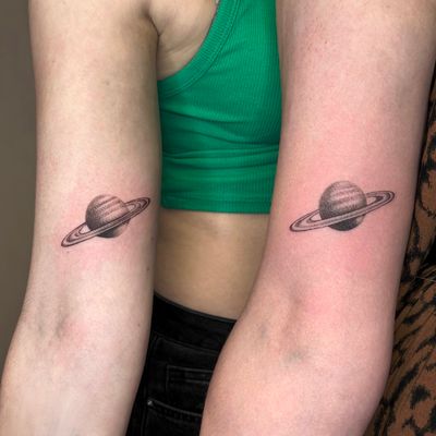 Illustrative dotwork tattoo of Saturn planet, skillfully done by Tas Kal.