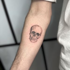 A unique black and gray skull tattoo featuring intricate dotwork details, created by tattoo artist Tas Kal.