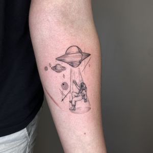 Capture the mystique of the night sky with this exquisite dotwork and fine line tattoo featuring a moon, astronaut, UFO, and Saturn. By Tas Kal.