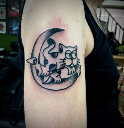 Elegant black & gray traditional tattoo featuring a mystical moon and a mysterious cat crafted by the talented artist Goblyn Crew.
