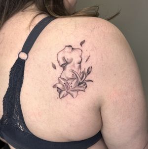 Unique dotwork and fine line tattoo featuring a statue and lily motif, done by Tas Kal in an illustrative style.