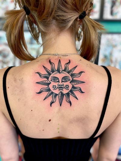 Traditional black and grey Sun tattoo