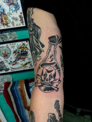 Get inked with a classic traditional tattoo of a poison bottle by River Tatts. A timeless design for a bold statement.