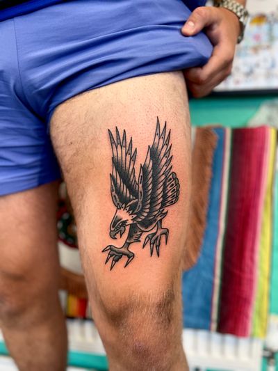 Experience the power and beauty of a traditional eagle tattoo designed by the talented artist River Tatts. Perfect for those seeking a bold and timeless design.
