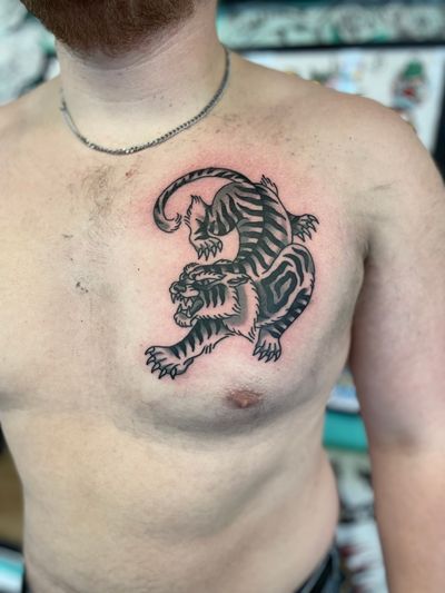 Experience the fierce beauty of a traditional tiger tattoo expertly crafted by River Tatts. Bold lines and vibrant colors bring this majestic creature to life.