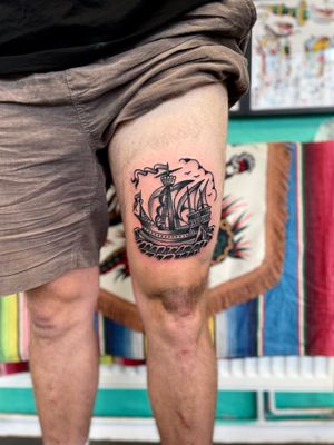 Sail away with this classic traditional ship tattoo done by renowned artist River Tatts. Timeless and bold design perfect for any tattoo enthusiast.