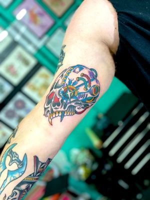 Get a classic traditional tattoo of a skull done by the talented artist River Tatts. Perfect for those who love spooky and bold designs.
