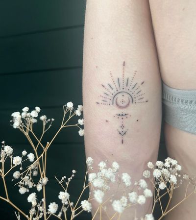 Elegant ornamental design featuring a sun and moon by Abbie Lou, incorporating intricate dotwork and fine line techniques.