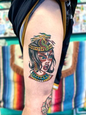 Experience the elegance of Cleopatra with this stunning traditional tattoo by River Tatts. Timeless beauty at its finest.