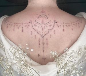 Experience the beauty of Abbie Lou's expertly crafted dainty dotwork and fine line ornamental tattoo design.