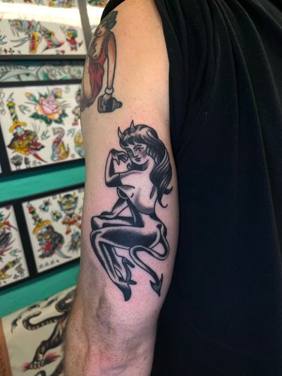 Get inked with a classic devil meets pin up girl design by the talented artist River Tatts. A timeless piece with a twist of edginess.
