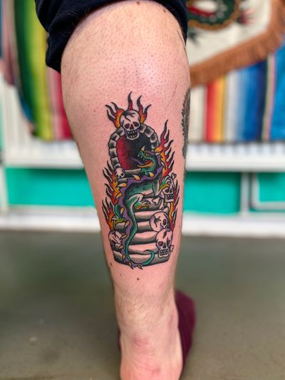 Experience the fierce strength of a dragon, the mysterious allure of a skull, and the never-ending journey of a stair in this bold traditional tattoo by River Tatts.