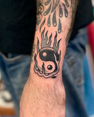 Experience the harmony of opposites with this fiery ying yang design by River Tatts.