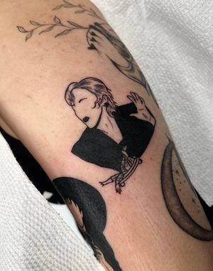 Get a sleek minimalist movie tattoo by Miss Vampira, combining blackwork and illustrative styles for a unique look.