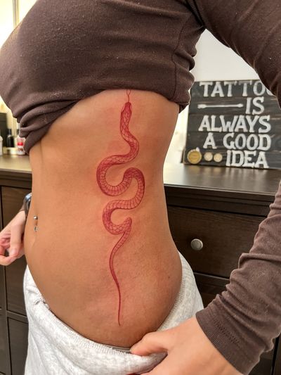 Get a striking red snake tattoo in fine line illustrative style by Ion Caraman. Make a bold statement with this unique design.