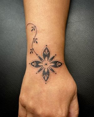 Experience the artistry of Indigo Forever Tattoos with this intricate blackwork flower design, hand-poked with fine lines.