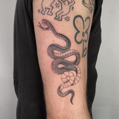 Capture the mystique of the snake with this stunning illustrative tattoo by the talented artist Charlie Macarthur.