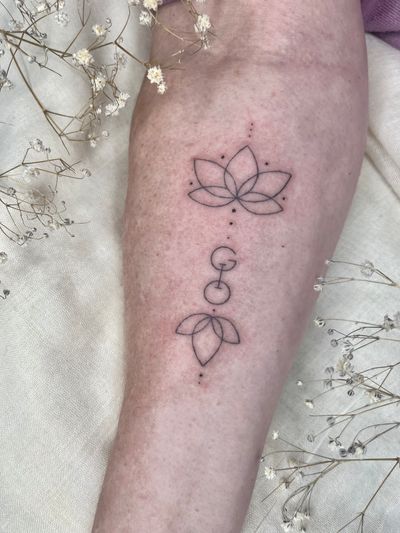 Elegant fine line lotus design with geometric and ornamental elements by talented artist Abbie Lou.