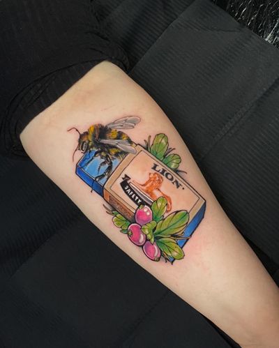 Vibrant and detailed tattoo of a bee hovering over a matchbox, expertly executed by Jethro Wood in neo-traditional style.