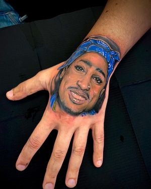 Get a realistic and vibrant portrait of iconic rapper 2Pac by tattoo artist Jethro Wood. Stand out with this bold and detailed design.