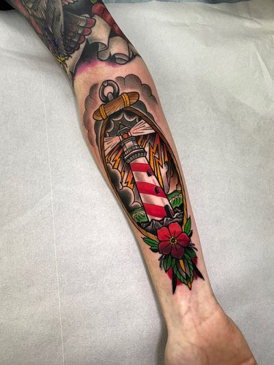 Capture the guiding light of a neo-traditional lighthouse tattoo by the talented artist Jethro Wood. Embrace the timeless beauty and symbolism of this maritime motif.