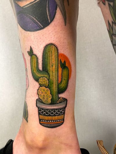 Beautiful neo-traditional tattoo featuring a cactus and vase, created by the talented artist Jethro Wood.