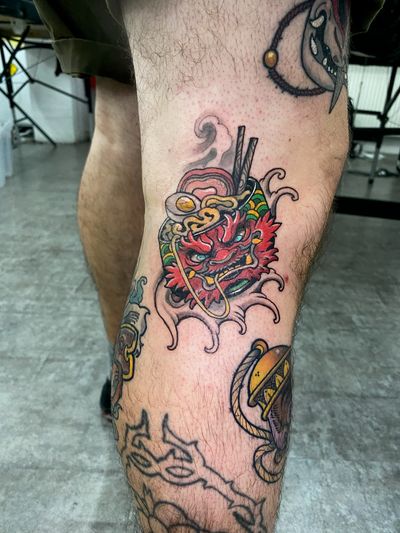 Experience the mystical fusion of dragon and lamen motifs in this vibrant neo-traditional tattoo by Jethro Wood.