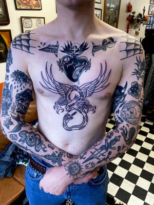 Get inked with a stunning traditional tattoo featuring a snake, eagle, sword, patchwork, and sacred heart motif by flashbyaj.